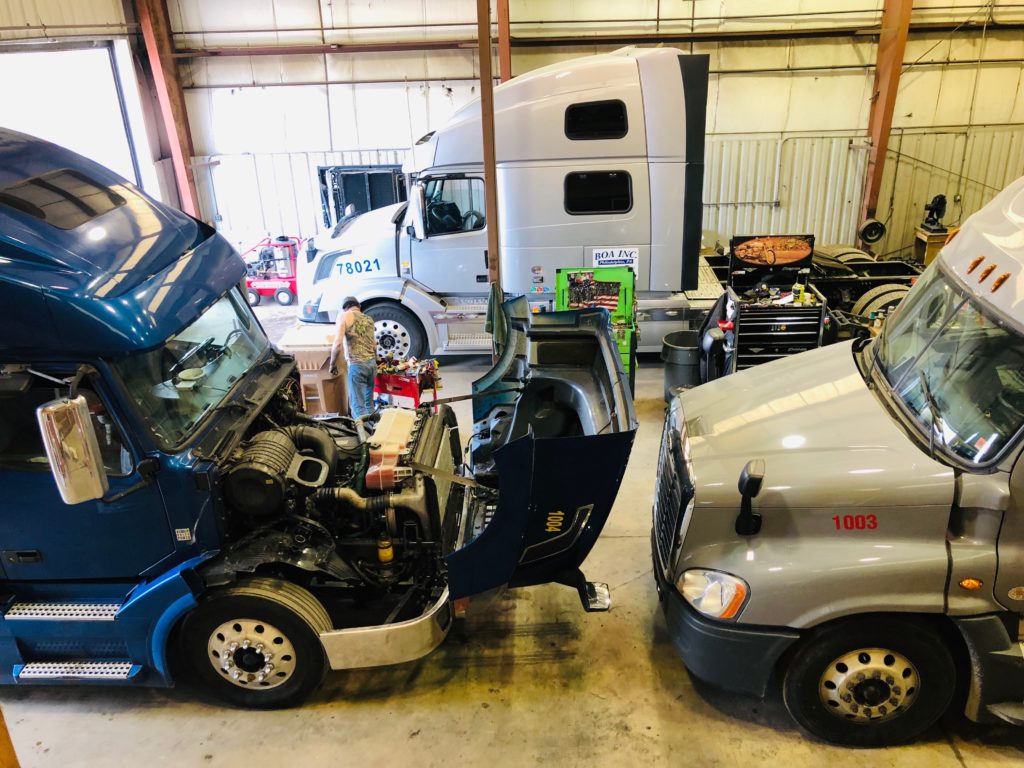 Trucks being serviced in the garage.